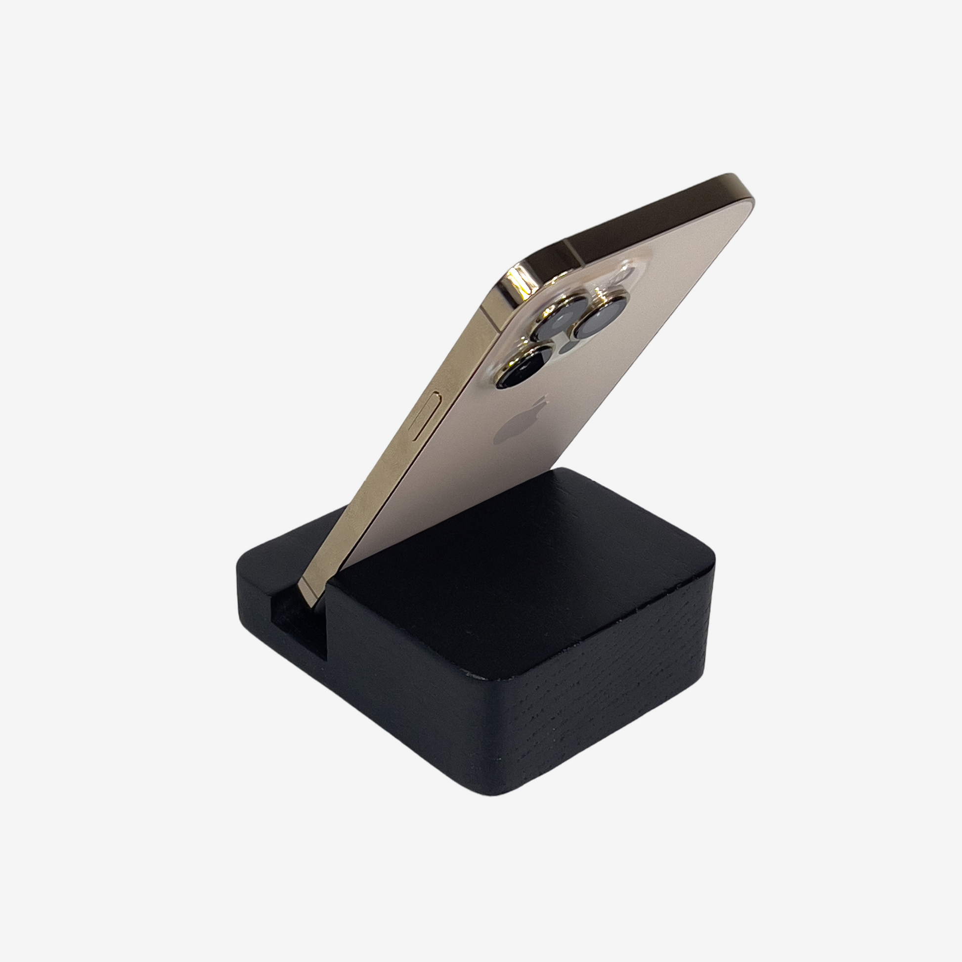Lux Navia black wooden phone stand holding a smartphone, with the image taken from the back, combining a minimalist aesthetic with practical functionality for any workspace or home.