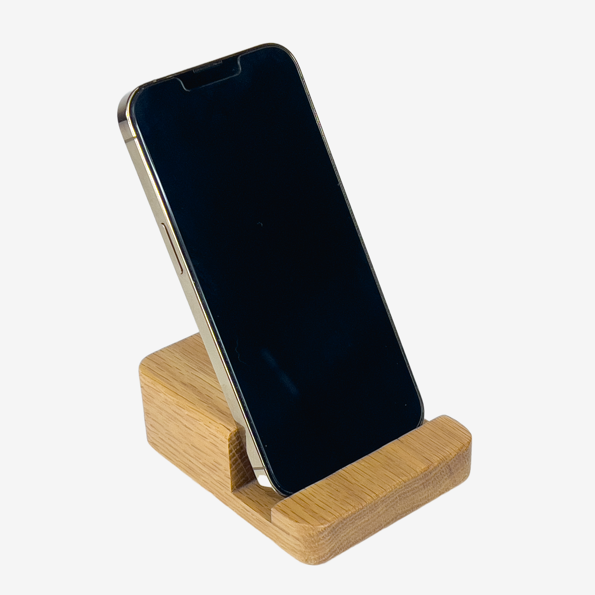 Lux Navia oak wooden phone stand holding a smartphone, with the image taken from the front, combining a minimalist aesthetic with practical functionality for any workspace or home.