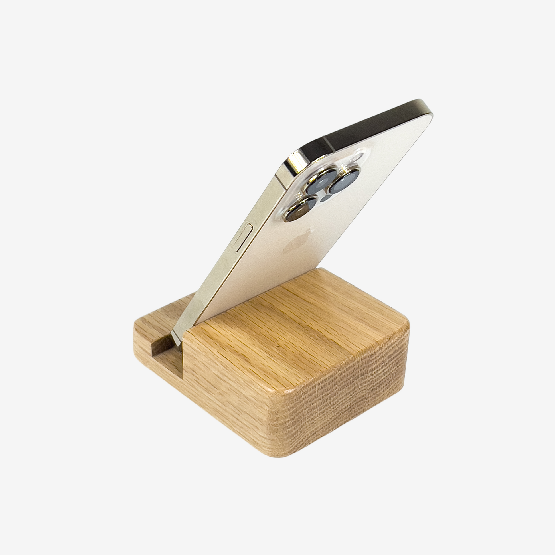 Lux Navia oak wooden phone stand holding a smartphone, with the image taken from the back, combining a minimalist aesthetic with practical functionality for any workspace or home.
