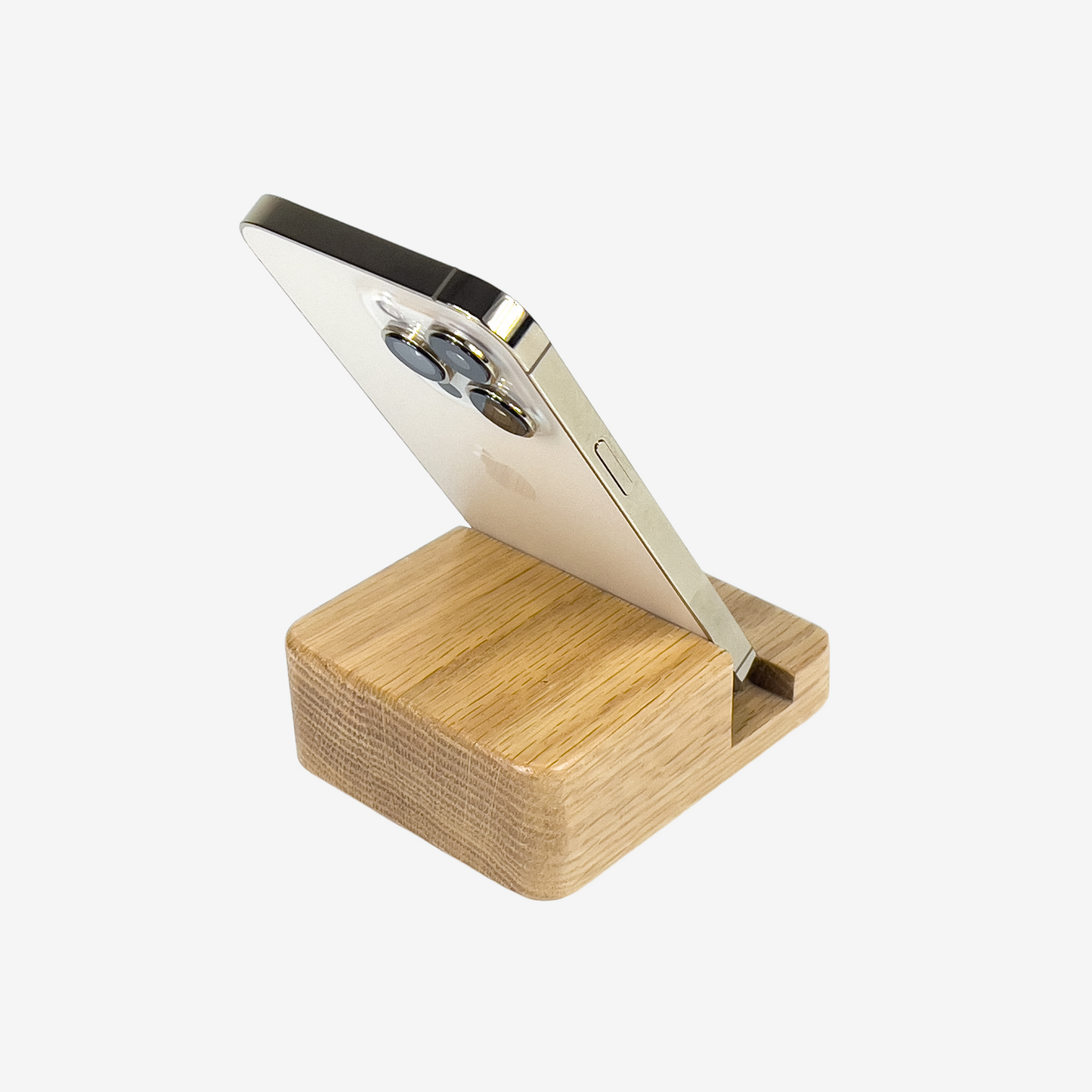 Lux Navia oak wooden phone stand holding a smartphone, with the image taken from the back, combining a minimalist aesthetic with practical functionality for any workspace or home.