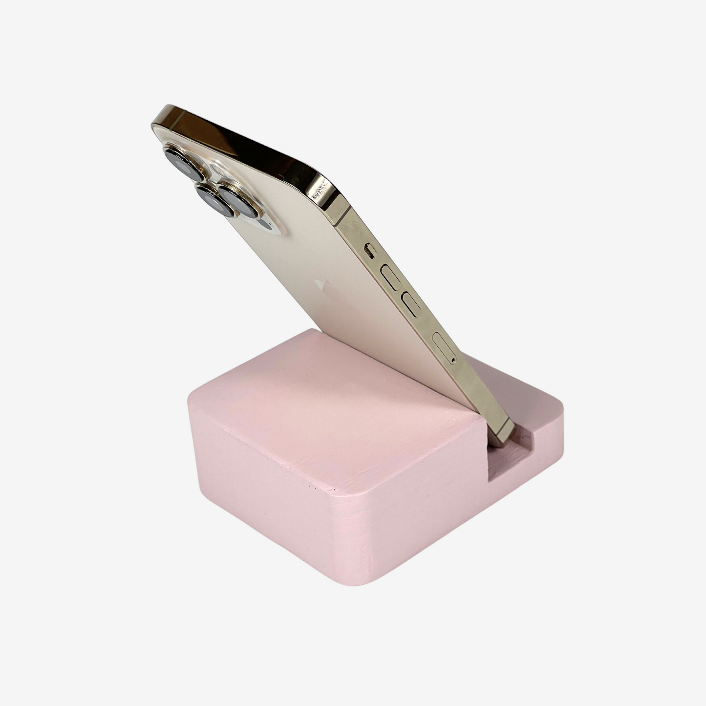 Lux Navia pink wooden phone stand holding a smartphone, with the image taken from the back, combining a minimalist aesthetic with practical functionality for any workspace or home.