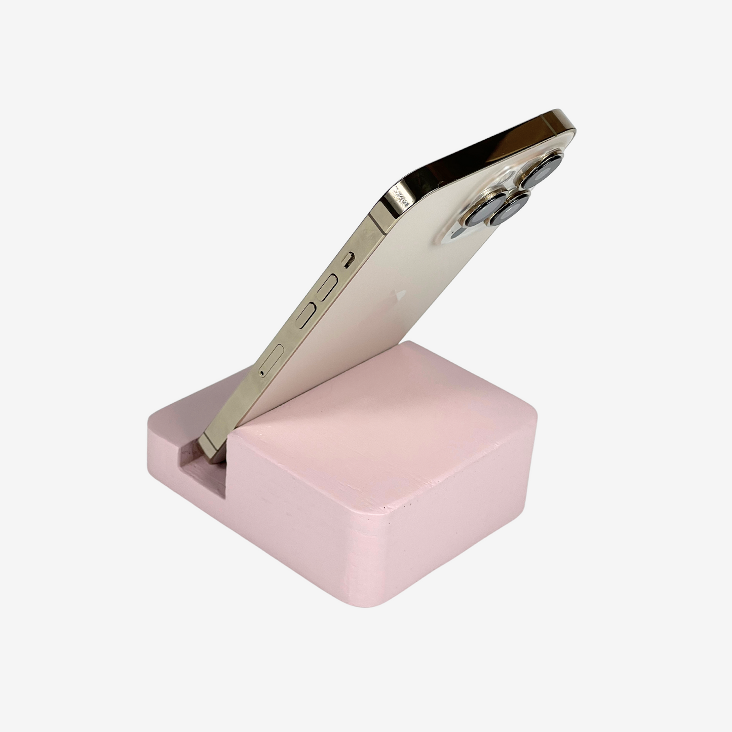Lux Navia pink wooden phone stand holding a smartphone, with the image taken from the back, combining a minimalist aesthetic with practical functionality for any workspace or home.