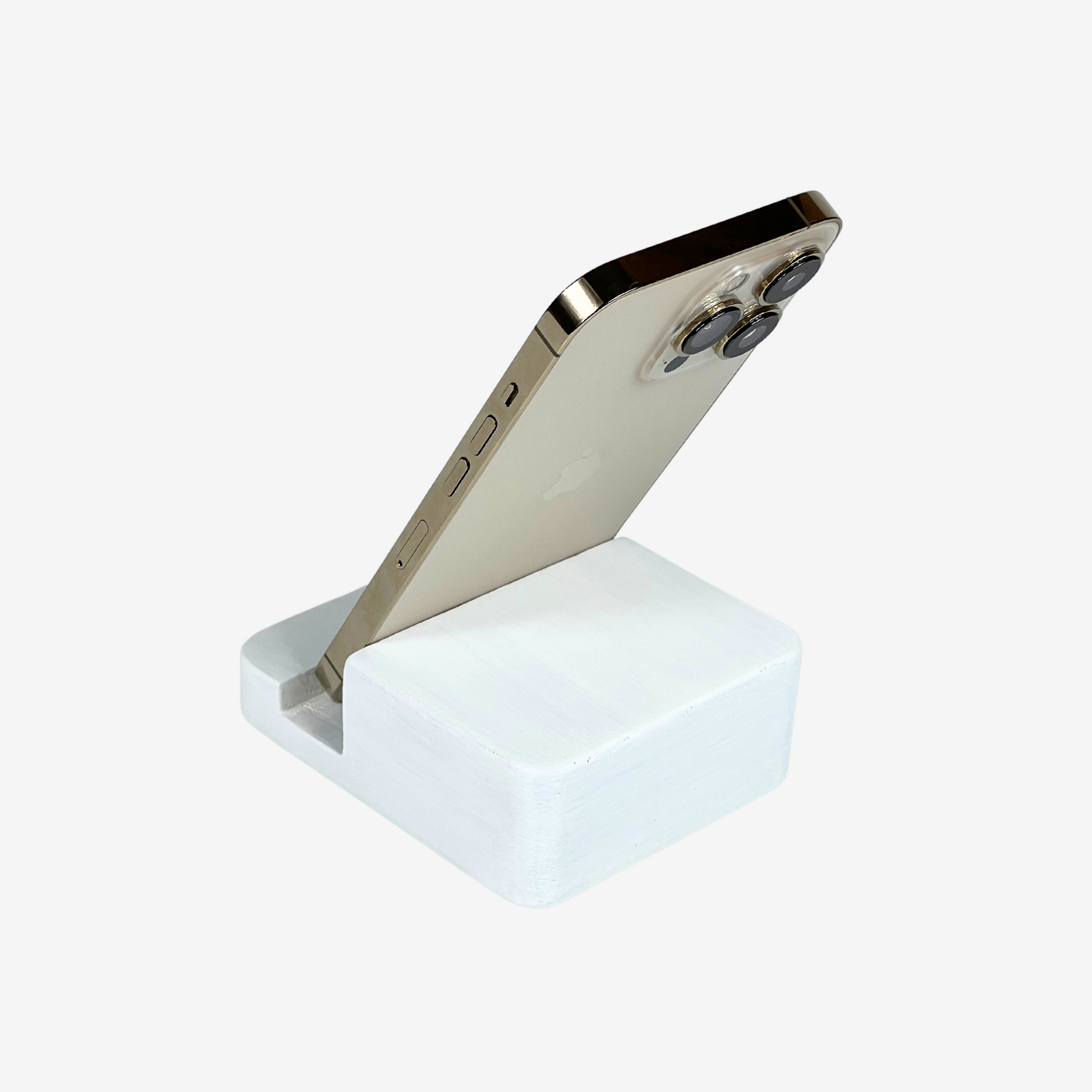 Lux Navia white wooden phone stand holding a smartphone, with the image taken from the back, combining a minimalist aesthetic with practical functionality for any workspace or home.